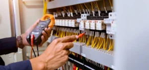 Electrician inspecting a home's electrical panel to diagnose flickering lights in Portland, OR