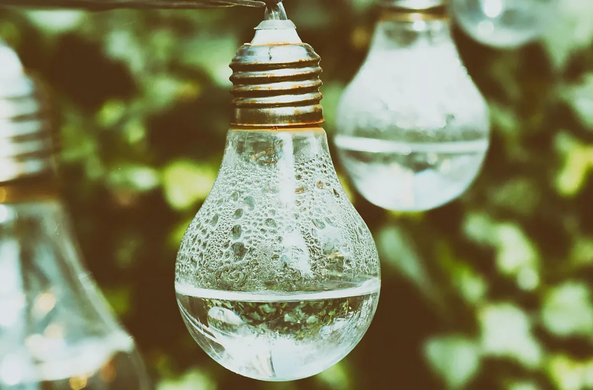 Indoor lightbulbs attached to outdoor lighting installation.
